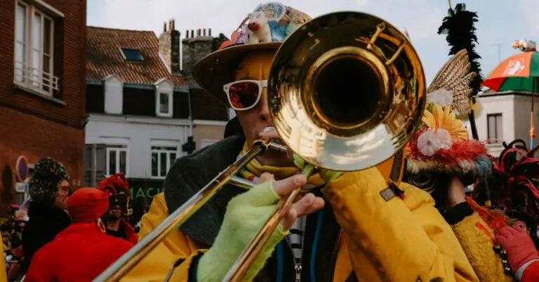 man playing trombone in the street